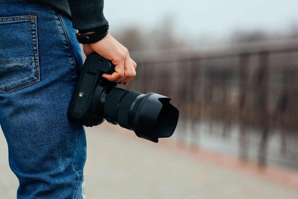 close-up-view-male-hand-holding-professional-camera-street